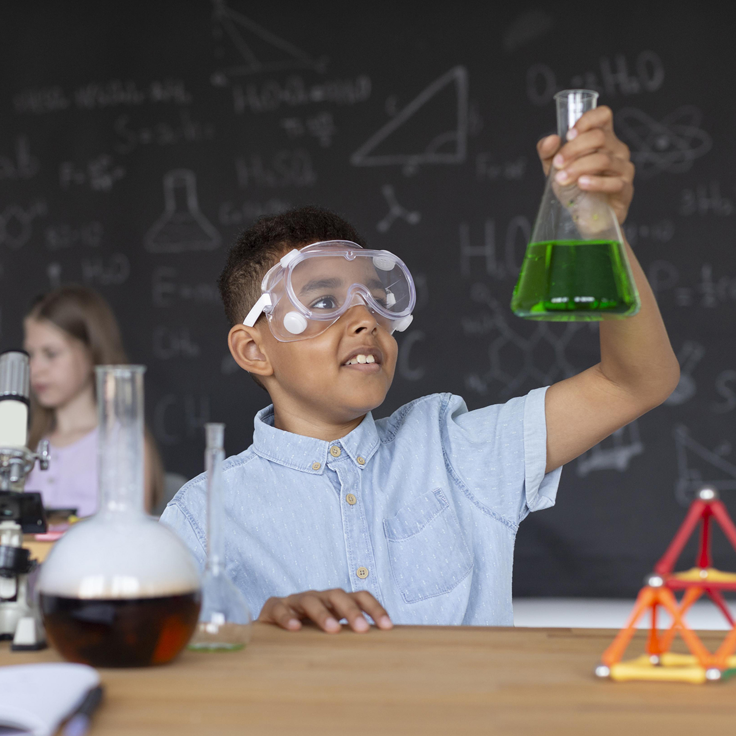 Elementary student with chemistry beaker