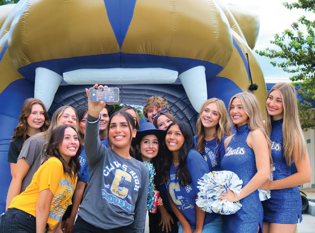 Clovis High cheerleaders and students pose for a selfie.