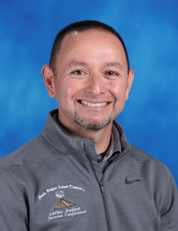 Mr. Castro with the blue school photo background