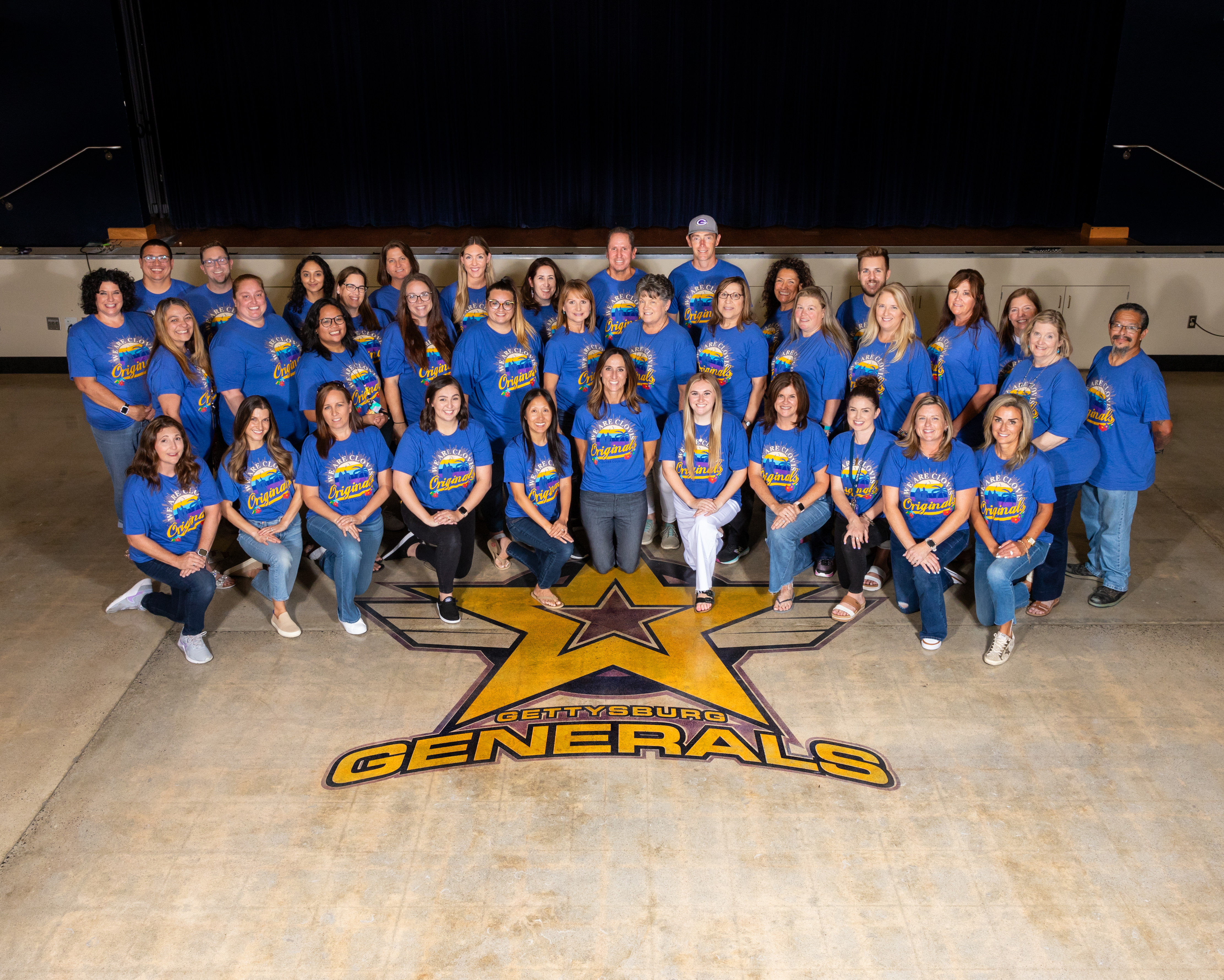 Gettysburg Staff wearing Blue CHS shirts on MPR floor with Generals emblem