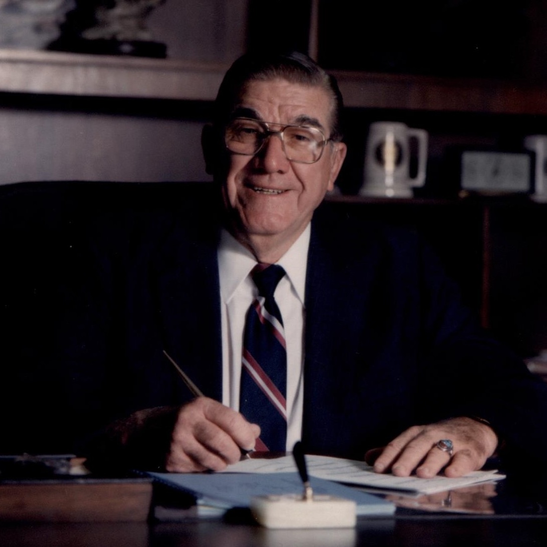 Floyd "Doc" Buchanan sitting at a desk